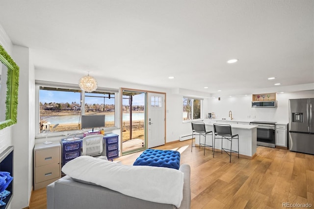 living area featuring recessed lighting and light wood-style floors