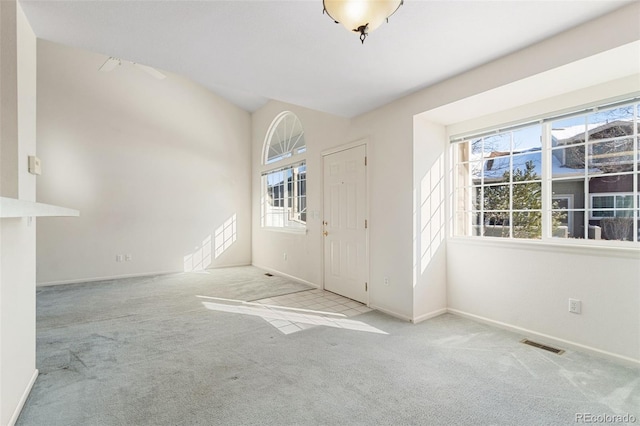 view of carpeted foyer entrance