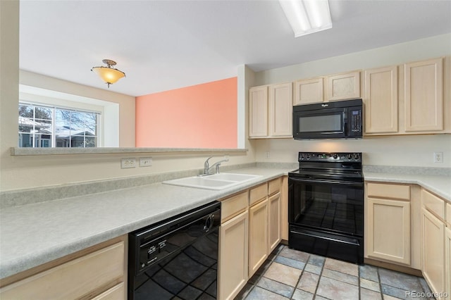 kitchen featuring sink, light brown cabinets, and black appliances