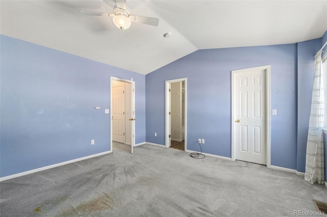 unfurnished bedroom with carpet floors, ensuite bath, vaulted ceiling, and ceiling fan