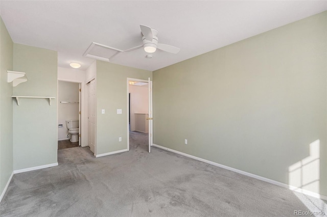 unfurnished bedroom featuring ceiling fan, connected bathroom, light colored carpet, and a closet