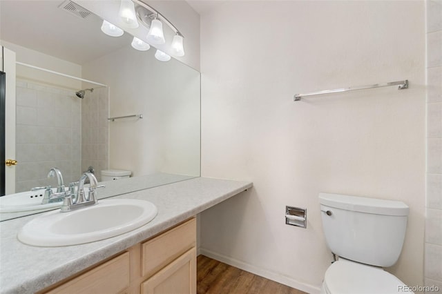 bathroom with hardwood / wood-style flooring, vanity, and toilet