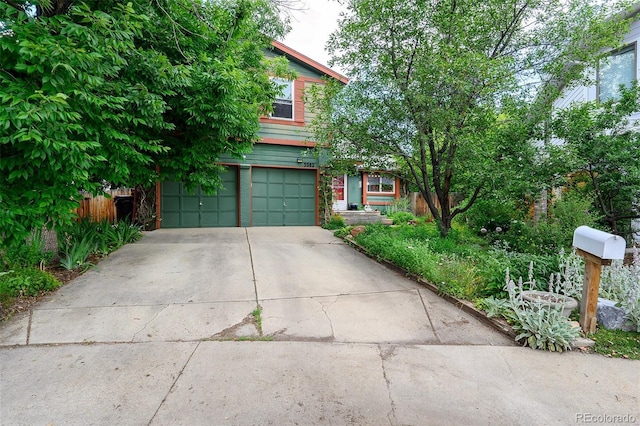 3982 Arbol Ct, Boulder, CO 80301 - view of property hidden behind natural elements with a garage and concrete driveway