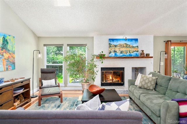 3982 Arbol Ct, Boulder, CO 80301 - living room featuring a textured ceiling, wood finished floors, and a fireplace