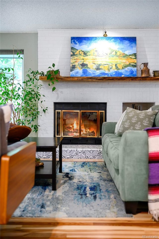 3982 Arbol Ct, Boulder, CO 80301 - living area with a textured ceiling, a fireplace, and wood finished floors