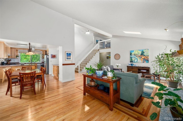 3982 Arbol Ct, Boulder, CO 80301 - living area with stairs, high vaulted ceiling, light wood finished floors, and a ceiling fan