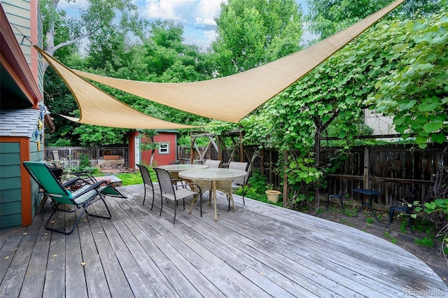 3982 Arbol Ct, Boulder, CO 80301 - wooden terrace with a storage unit, outdoor dining space, and a fenced backyard