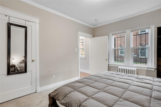 bedroom featuring multiple windows, a closet, radiator, and crown molding