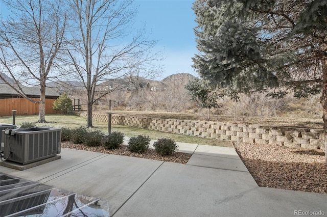 view of patio with central AC and a mountain view