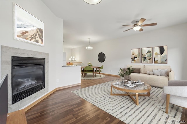 living room featuring a tile fireplace, ceiling fan, and hardwood / wood-style flooring