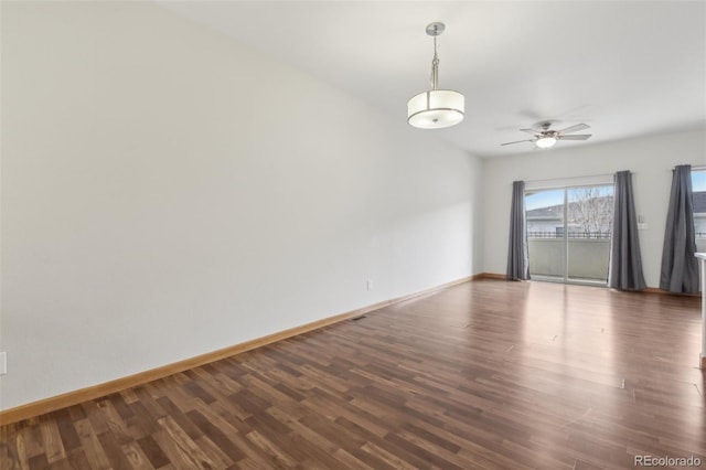 unfurnished room with dark hardwood / wood-style flooring and ceiling fan