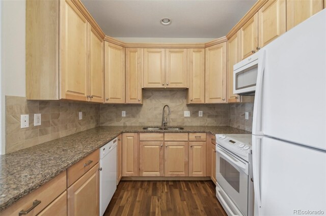 kitchen with light brown cabinetry, white appliances, dark wood-type flooring, sink, and stone countertops