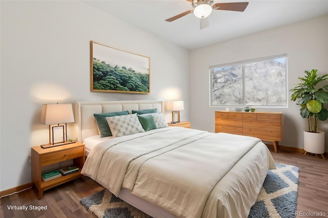 bedroom with dark hardwood / wood-style floors and ceiling fan