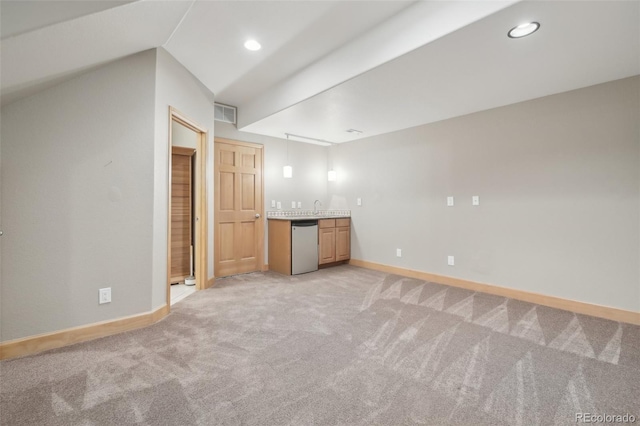 additional living space featuring light carpet, indoor bar, and lofted ceiling