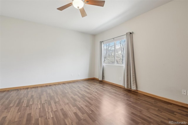 empty room with ceiling fan and dark hardwood / wood-style floors