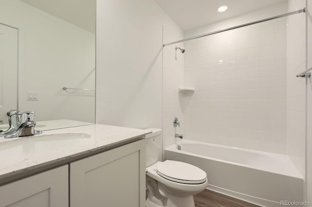 22094 E 39th Pl, Aurora, CO 80019 - bathroom featuring wood finished floors, vanity, bathing tub / shower combination, and recessed lighting