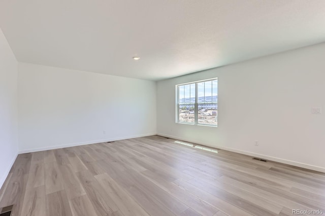 22094 E 39th Pl, Aurora, CO 80019 - unfurnished room with light wood-style floors and baseboards