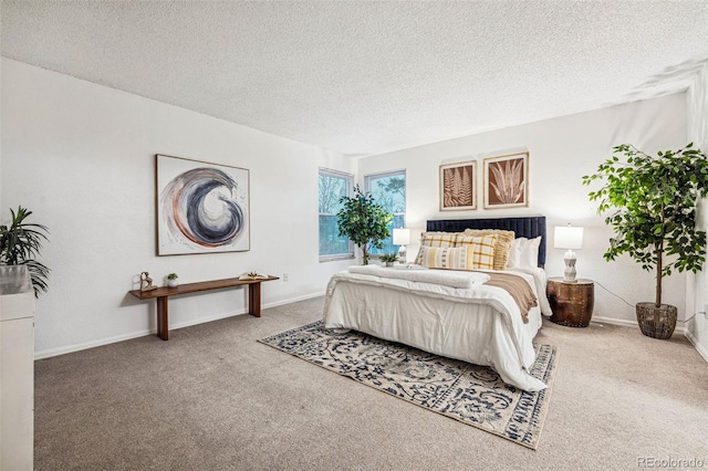 bedroom with a textured ceiling, baseboards, and carpet flooring