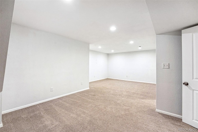 finished below grade area with carpet floors, baseboards, and recessed lighting