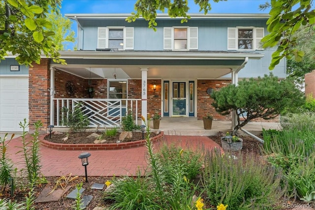 3765 E Easter Dr, Centennial, CO 80122 - view of front facade with a porch, brick siding, and a garage