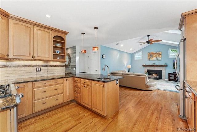 3765 E Easter Dr, Centennial, CO 80122 - kitchen featuring light wood-style flooring, ceiling fan, a peninsula, a glass covered fireplace, and vaulted ceiling