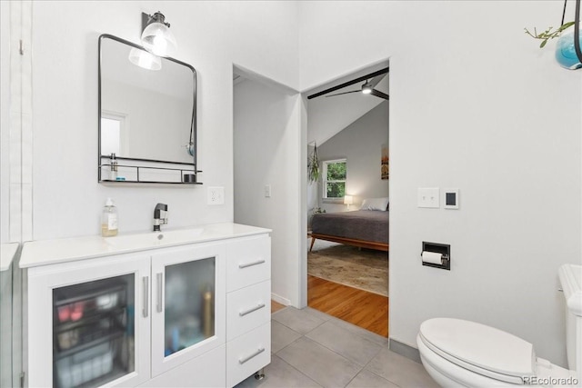 3765 E Easter Dr, Centennial, CO 80122 - bathroom with vanity, connected bathroom, tile patterned flooring, and lofted ceiling
