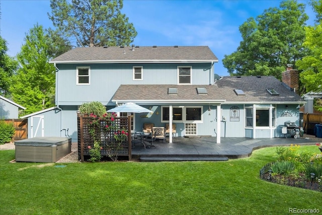 3765 E Easter Dr, Centennial, CO 80122 - back of house featuring a hot tub, a shingled roof, and a deck