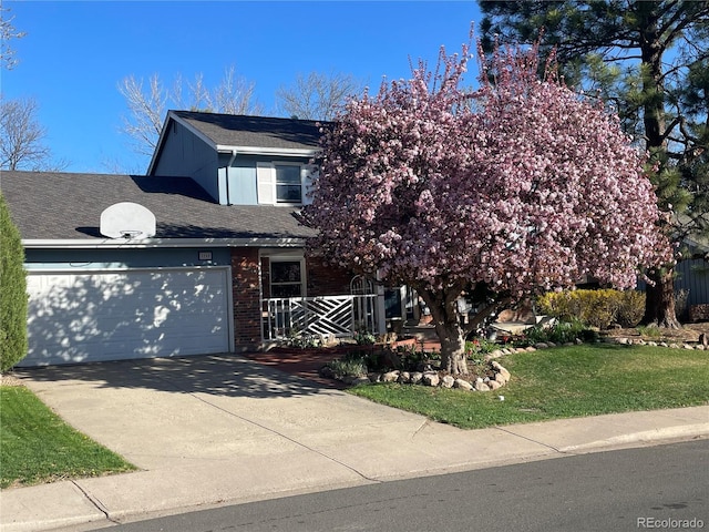 3765 E Easter Dr, Centennial, CO 80122 - view of front of home featuring concrete driveway, a garage, brick siding, and a shingled roof