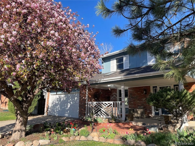 3765 E Easter Dr, Centennial, CO 80122 - view of front of house with a porch, brick siding, and driveway