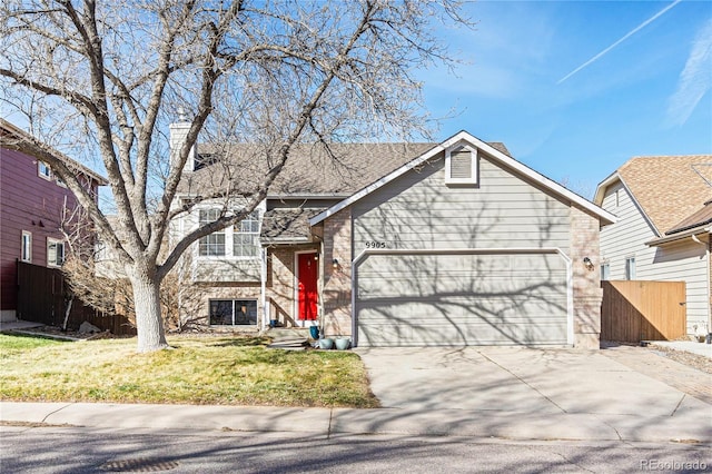 view of front of property featuring an attached garage, a chimney, concrete driveway, a front lawn, and brick siding