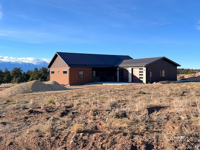 rear view of property featuring a mountain view