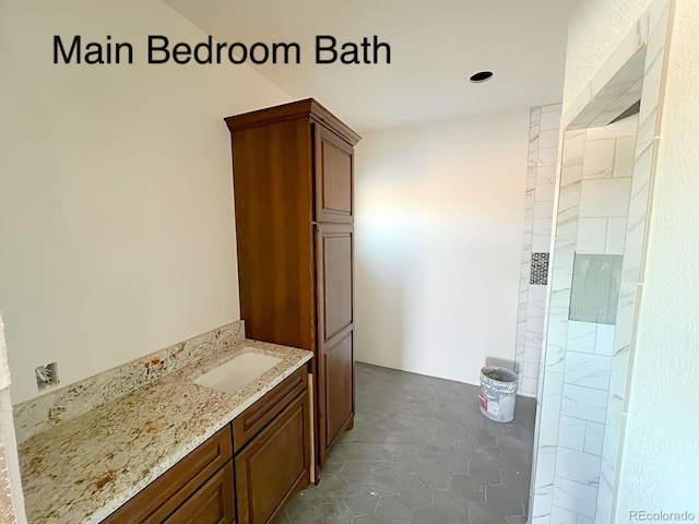 bathroom featuring tile patterned flooring, a shower, and sink