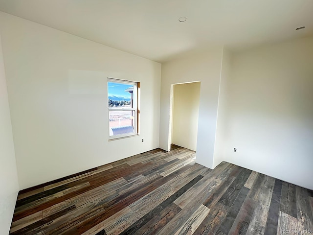 empty room featuring dark wood-type flooring