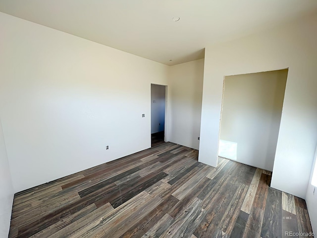 spare room featuring dark wood-type flooring