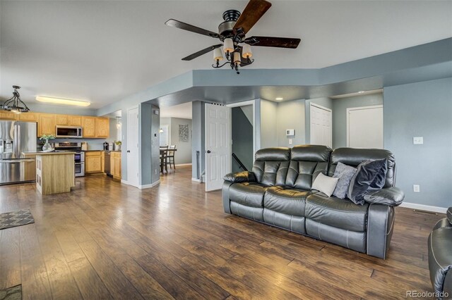 8060 Willowick Ct, Colorado Springs, CO 80925 - living area featuring ceiling fan, dark wood-style floors, and baseboards