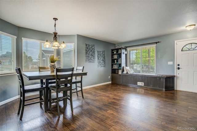 8060 Willowick Ct, Colorado Springs, CO 80925 - dining area featuring a chandelier, baseboards, and wood finished floors
