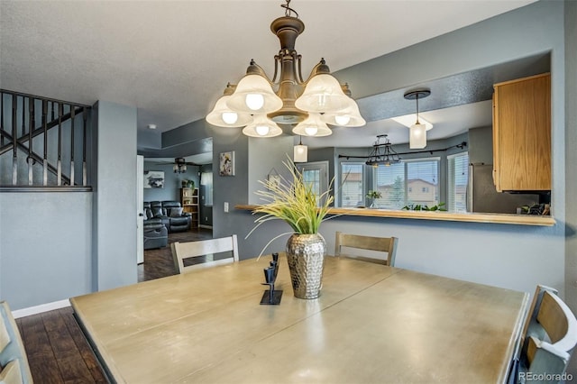 8060 Willowick Ct, Colorado Springs, CO 80925 - dining space featuring a chandelier, stairway, ceiling fan, baseboards, and dark wood-style floors