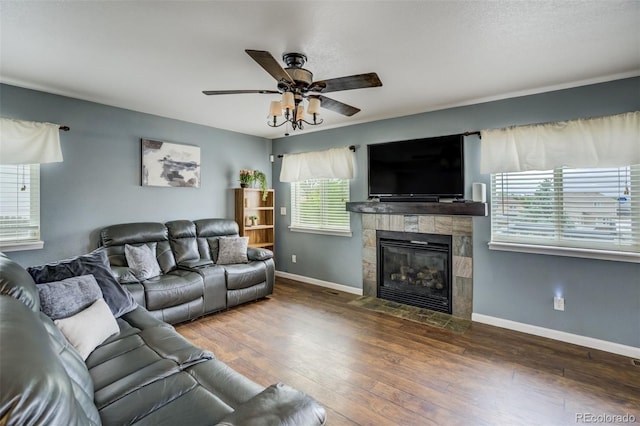 8060 Willowick Ct, Colorado Springs, CO 80925 - living area with a ceiling fan, a tile fireplace, hardwood / wood-style floors, and baseboards