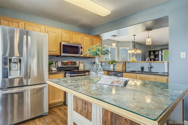 8060 Willowick Ct, Colorado Springs, CO 80925 - kitchen with appliances with stainless steel finishes, a sink, dark wood finished floors, a chandelier, and decorative light fixtures