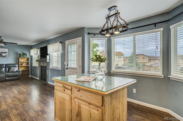 8060 Willowick Ct, Colorado Springs, CO 80925 - kitchen with plenty of natural light, open floor plan, a fireplace, and dark wood-style floors