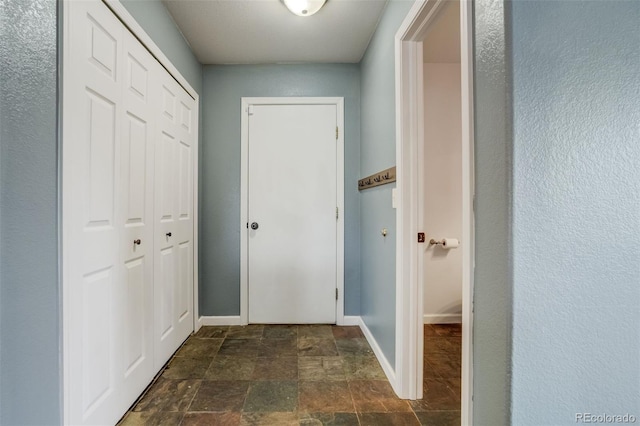 8060 Willowick Ct, Colorado Springs, CO 80925 - hall featuring stone finish flooring and baseboards