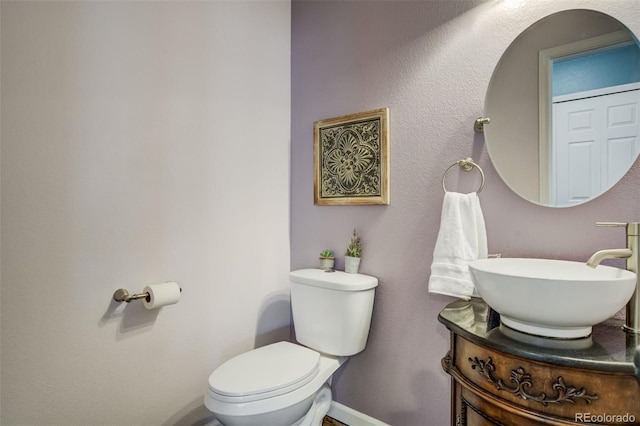 8060 Willowick Ct, Colorado Springs, CO 80925 - half bath featuring toilet, vanity, and baseboards