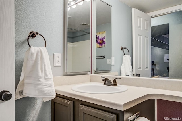 8060 Willowick Ct, Colorado Springs, CO 80925 - bathroom featuring vanity and a textured wall