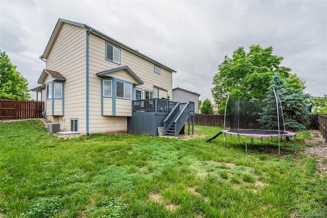 8060 Willowick Ct, Colorado Springs, CO 80925 - back of house featuring a trampoline, a deck, stairway, and central AC