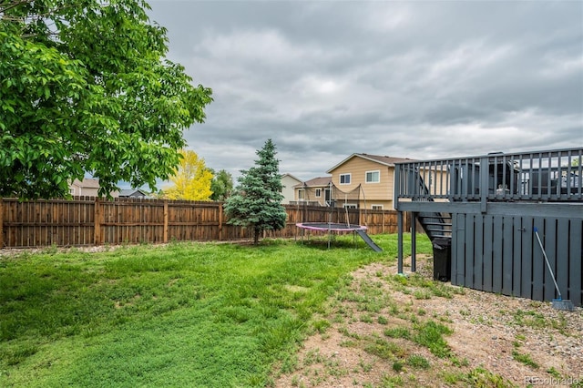 8060 Willowick Ct, Colorado Springs, CO 80925 - view of yard with a trampoline and a wooden deck