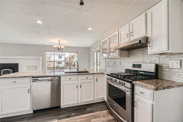 kitchen with white cabinetry, kitchen peninsula, and stainless steel appliances