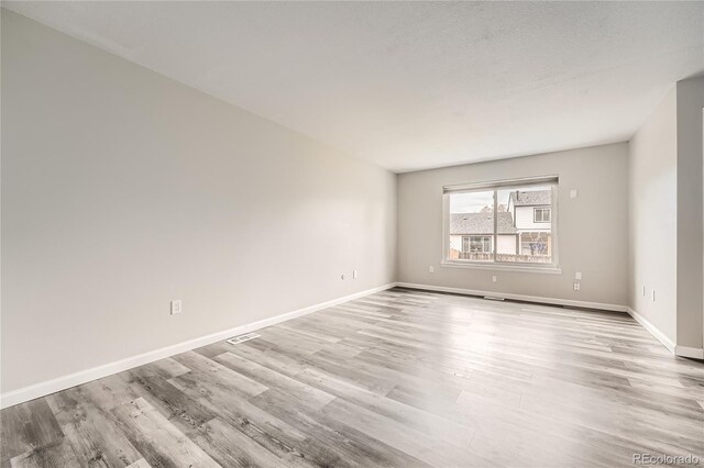 spare room featuring light wood-type flooring