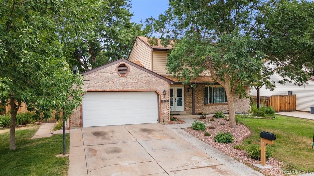 view of front property featuring a front yard and a garage