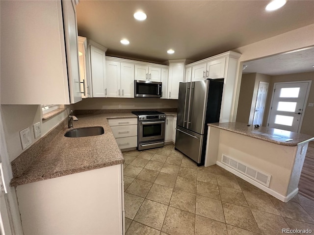 kitchen with a sink, white cabinets, visible vents, appliances with stainless steel finishes, and recessed lighting
