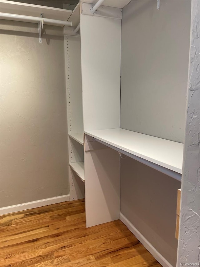spacious closet with light wood-style flooring